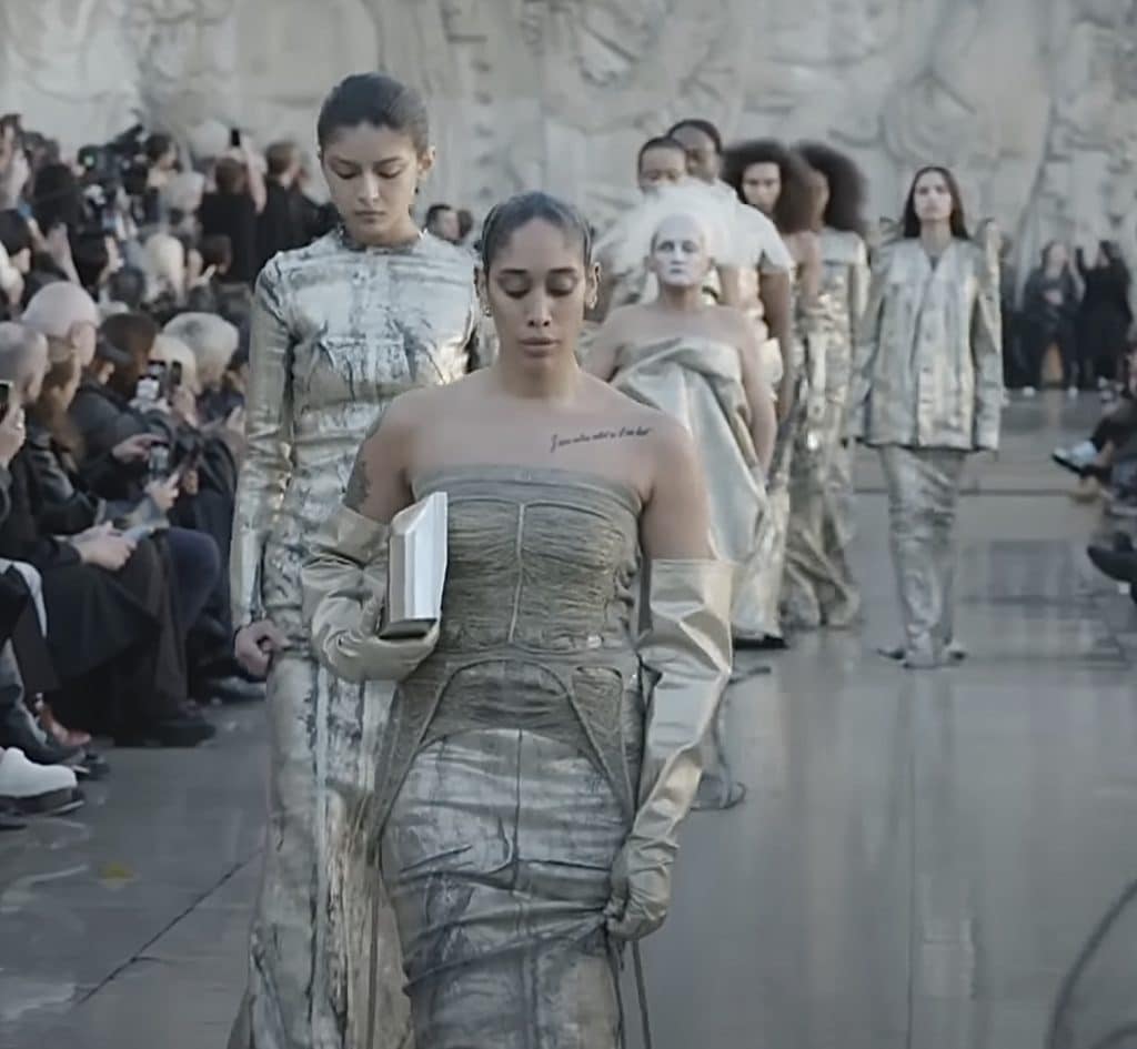 line of models all dressed up in gray and silver clothing